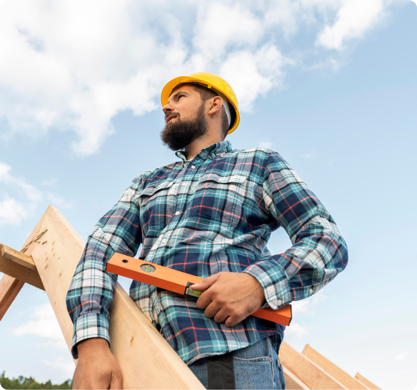 A man holding a level on a roof.
