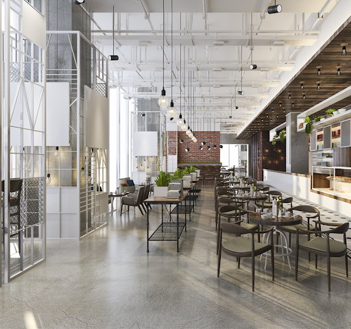A room full of tables and chairs with hanging lights.